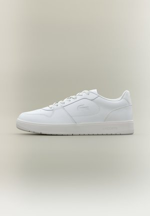 White leather sneaker with round toe, lace-up front, and textured rubber sole. Features subtle logo detailing on the side and heel.