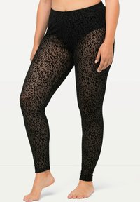 Leggings in rete neri con un motivo a stampa leopardata, design a vita alta e tessuto elasticizzato che si adatta al corpo.