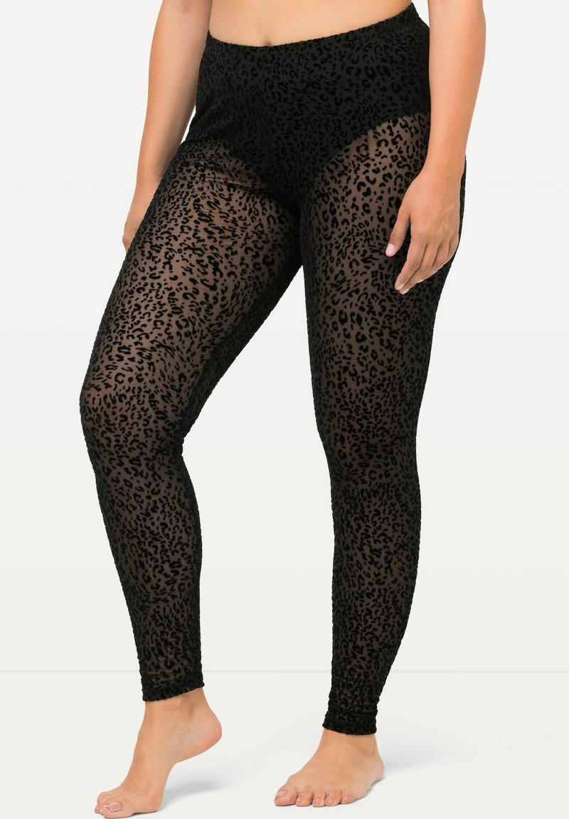 Leggings in rete neri con un motivo a stampa leopardata, design a vita alta e tessuto elasticizzato che si adatta al corpo.