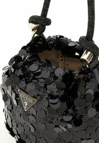 Sac seau noir pailleté de la marque Guess, avec des poignées en perles nouées et des finitions dorées, partiellement ouvert montrant la doublure intérieure beige.