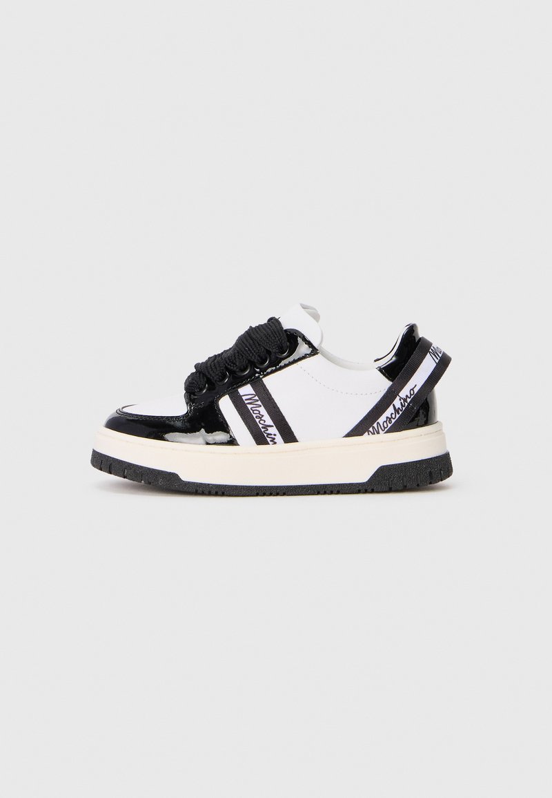 Black and white sneakers with patent leather accents, textured laces, and logo strap. Features a chunky sole with rubber tread.