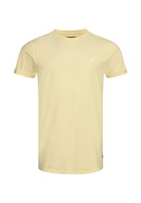 Yellow cotton t-shirt with short sleeves, contrasting cuff trim, round neckline, and small white logo on the chest. Smooth texture.