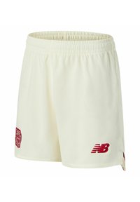 Pantaloncini sportivi color crema con tessuto testurizzato, dotati di una fascia elastica in vita, accenti di logo rossi e una toppa sul lato.