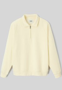 Sweatshirt crème à manches longues avec demi-zip, col, poignets côtelés et étiquette de marque BZB à l'intérieur de l'encolure.