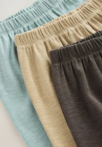 Tres pares de pantalones de lounge texturizados y acanalados en azul claro, beige y gris oscuro, con cinturillas elásticas, exhibidos en una disposición doblada.