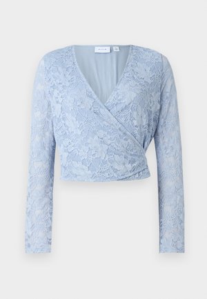 Light blue lace cropped top with a V-neck, long sleeves, and a wrap design. Features intricate floral patterns and a smooth inner lining.