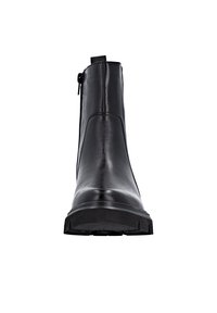 Black ankle boot made of polished leather, featuring a side zipper, chunky sole, and sleek design with minimal stitching and hardware accents.