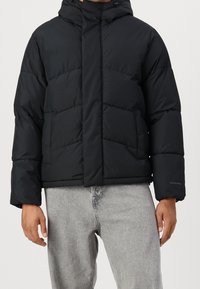 Black puffer jacket with a hood, featuring quilted sections, side pockets, and elastic cuffs. Made from a smooth, matte fabric.