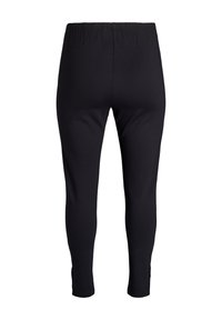 Čierne legíny s hladkým povrchom, elastickým pásom, rozparkami na členkoch a priliehavým strihom pre elegantný siluetu.