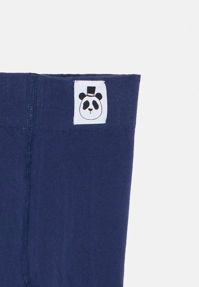 Tecido azul marinho com um pequeno rótulo branco com um rosto de panda a usar um chapéu-de-copa preto cosido perto da borda.