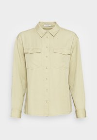 Light green button-up shirt with long sleeves, two front pockets, a collar, and a smooth fabric texture. Features small button details.