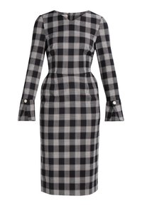 Svart- och vitt rutigt klänning med långa ärmar, en åtsittande siluett och utsvängda ärmslut, med en diskret halsringning.