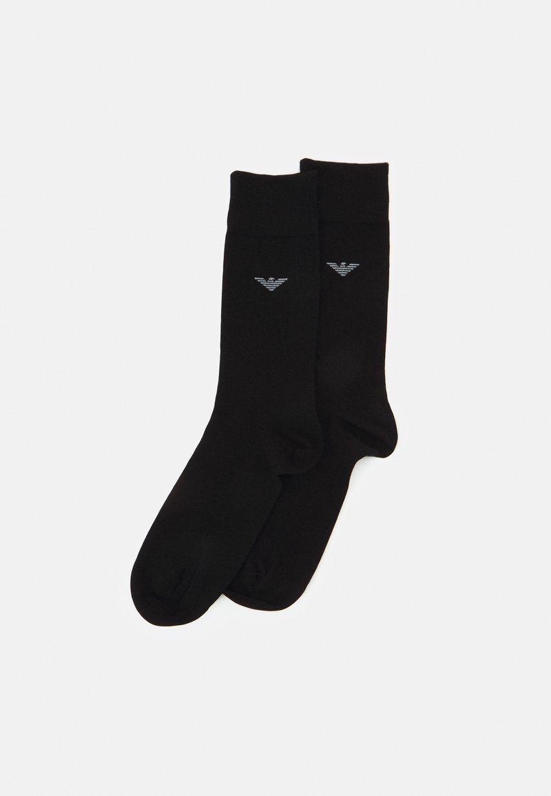Chaussettes noires en tissu doux arborant un logo discret en gris sur un côté. Elles présentent un design classique avec une bordure côtelée.