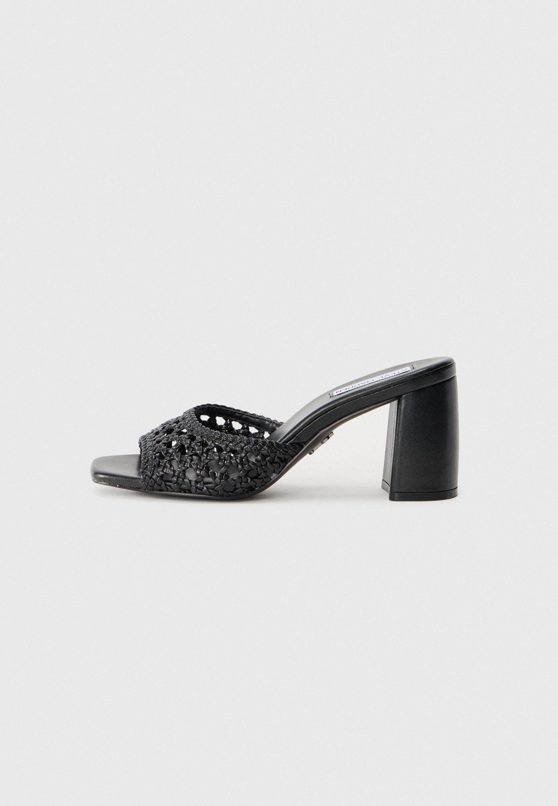 Black heeled mules featuring a woven upper with a cut-out pattern, square toe, and a chunky heel, crafted from synthetic materials.