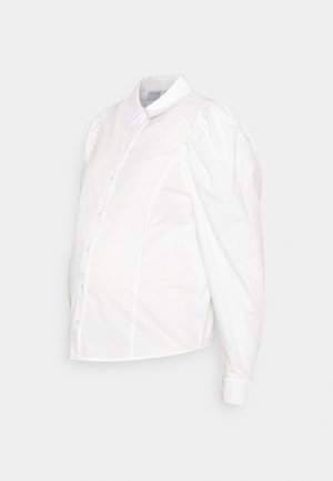 Camisa branca de botão com mangas bufantes, feita de algodão. Apresenta um colarinho clássico e um corpo ajustado com uma barra arredondada.