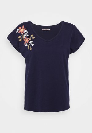 Navy blue short-sleeve V-neck shirt with embroidered orange and yellow floral design on the left shoulder.