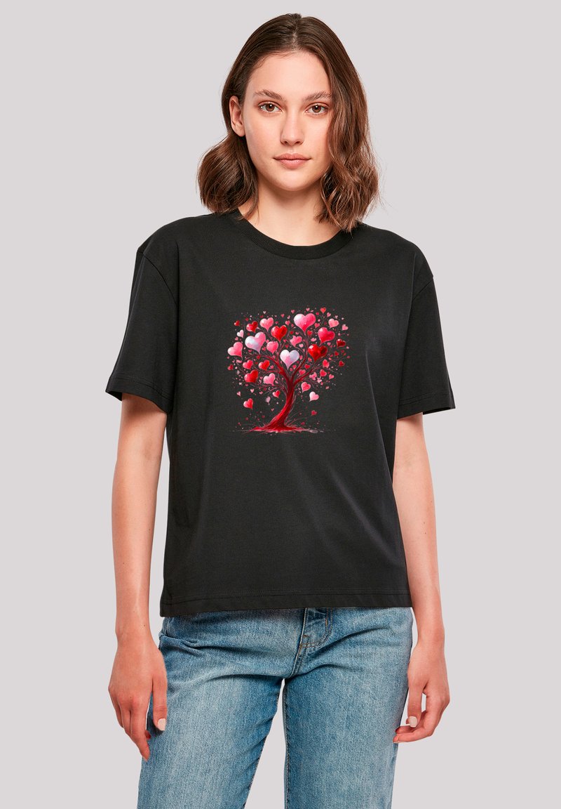 Black cotton t-shirt featuring a colorful tree design made of red and pink hearts, with a relaxed fit and crew neckline.