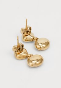 Goldohrringe mit einem skulpturalen Design, das oben abgerundet und unten größer und glatt gestaltet ist. Hergestellt aus glänzendem Metall mit einer polierten Oberfläche.