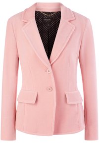 Rosa Cordjacke mit Reverskragen, zwei frontalen Taschen und Knopfverschluss. Innenfutter aus schwarzem Stoff mit weißen Pünktchen.