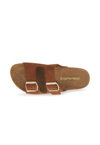 Brown suede sandal with two adjustable straps featuring silver buckles. Contoured footbed with beige lining, open-toe design.