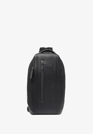 Black sleek leather backpack with vertical front zipper pocket, embossed brand name, and top handle, shown against a white background.