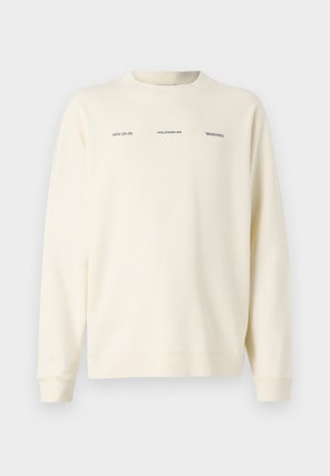 Cremefarvet sweatshirt med rund hals, lange ærmer og trykt tekst i sort. Blødt stof med en afslappet pasform.