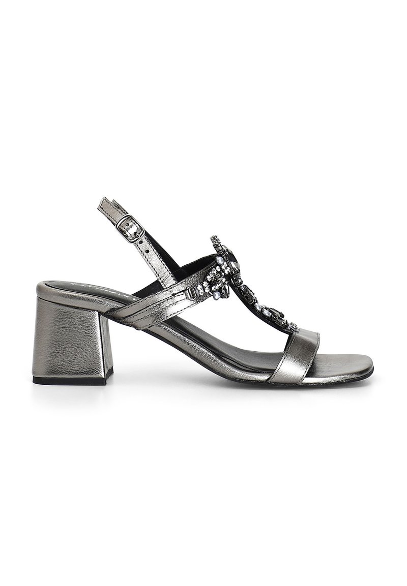 Sandal metallici argentati con tacco a blocco, caratterizzata da una fascia decorativa con strass, cinturino alla caviglia regolabile e una texture liscia.