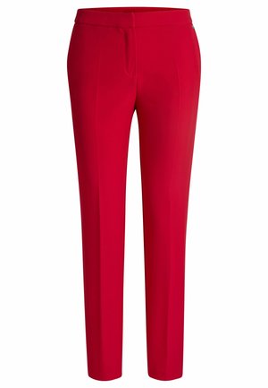 Red tailored trousers with a smooth texture, slim fit, and a flat front. Features subtle creases and a discreet logo on the waistband.