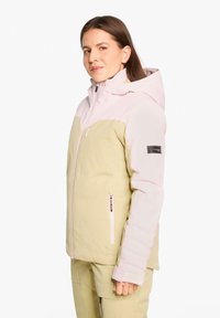 Hooded jacket in light green and pastel pink, featuring a zip front, side pockets, and a logo patch on the left arm. Soft, smooth texture.