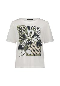 T-shirt blanc à manches courtes avec un motif floral en vert et noir, comportant des motifs abstraits et le mot "SHINE" dans une police moderne.