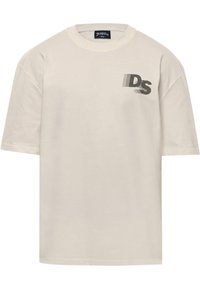 Cream cotton t-shirt with a round neckline and short sleeves. Features a black graphic design reading "DS" on the left chest area.
