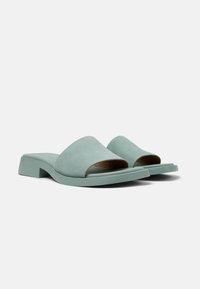 Mint-green slip-on sandals with a smooth suede upper, open toe design, and a minimalistic low block heel.