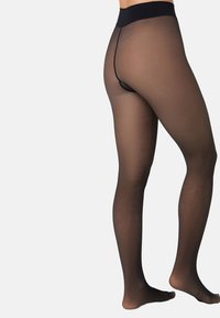 Sorte transparente strømpebukser med høj talje og tanga-snit bagpå. Glat tekstur, sømløst design og let udseende.