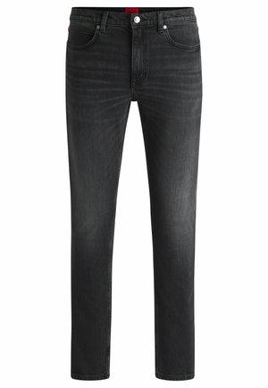 Fekete farmernadrág, slim fit szabással, klasszikus öt zsebes designnal, enyhe kopásokkal és piros márkajellel a deréknál.