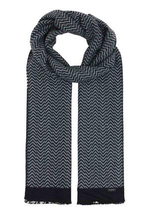 Dark blue and gray patterned wool scarf with chevron design and fringed ends, folded in a loop with label on one end.