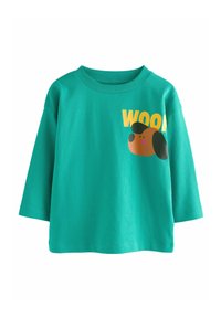 Maglietta turchese a maniche corte in cotone, con una grafica di un cane marrone e il testo "WOOF" in giallo. Collo a costine e vestibilità casual.