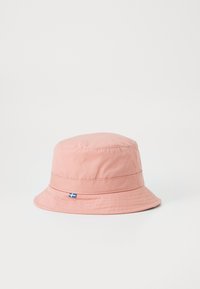 Pink bucket hat made of soft fabric with a wide brim and stitched detailing, featuring a small blue and yellow flag accent.