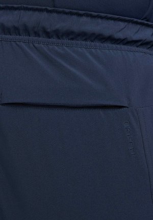 Navy blue DRI-FIT fabric with a smooth texture, featuring a horizontal pocket and subtle branding. Simple design with functional elements.