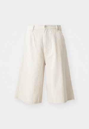 Beezid laiad püksid, mis on valmistatud puuvillast, sirge lõikega, ees on taskud ja taljes on nähtav nööbinupp.