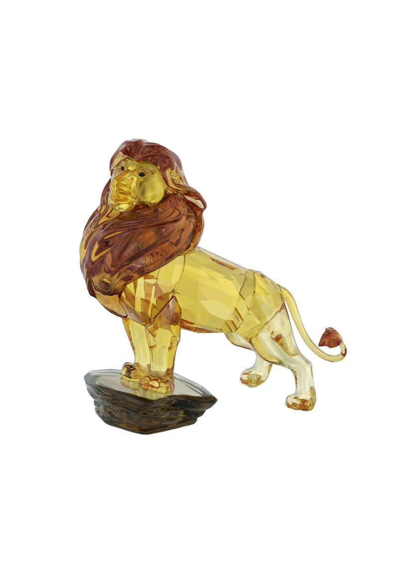 Figurita de león de cristal facetado con cuerpo amarillo y melena marrón, posada sobre una base de roca gris oscuro.