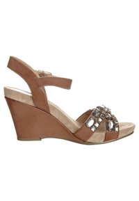 Brown wedge sandals with a soft suede footbed, featuring a decorative band with clear gems and an adjustable ankle strap.