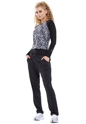 Black athletic joggers with a relaxed fit paired with a cropped, leopard print top featuring long black sleeves.