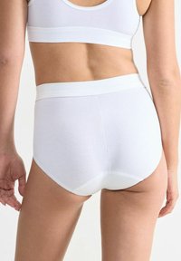 Weiße, hochgeschnittene Baumwollunterwäsche mit glatter Oberfläche, breitem elastischen Bund und ohne sichtbare Nähte an den Kanten.