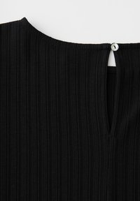 Black ribbed fabric with a small keyhole opening fastened by a single white button at the neckline.