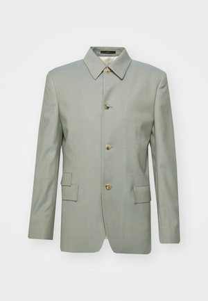 Blazer grigio chiaro realizzato in tessuto liscio, con colletto classico, quattro bottoni dorati e due tasche frontali. Silhouette su misura, strutturata.