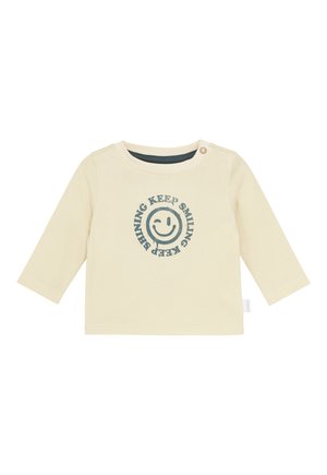 Hellebärige Langarm-Babyshirt mit Knopf an der Schulter und blauer Smiley-Gesicht-Grafik mit dem Text "HALTE DAS LÄCHELN, HALTE DAS STRAHLEN".