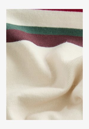 Kötött pulóver krémszínű alappal és bordó, zöld, valamint világosabb árnyalatú vízszintes csíkokkal. Puha textúrájú, sima megjelenésű.