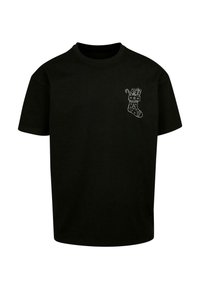 Tricou negru din bumbac, cu gât rotund și mâneci scurte, având un grafic alb cu o ciorap de Crăciun plin de cadouri și băte de zahăr.