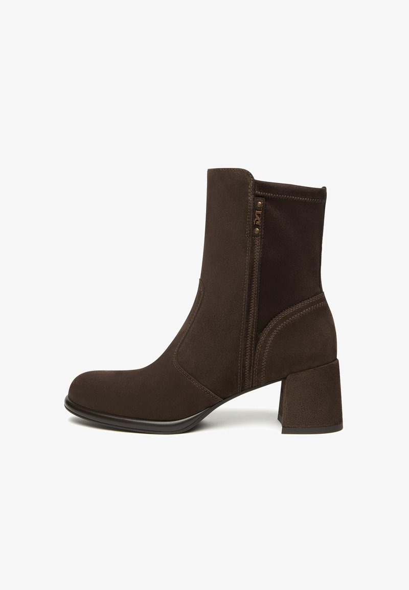 Brown suede ankle boot with a square toe, zipper detail, and a chunky heel. Smooth texture with contrasting dark fabric panels.