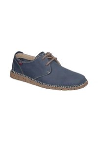 Zapato informal de cordones en azul marino con suela beige salpicada y costuras en contraste, diseñado para la comodidad y el uso diario.